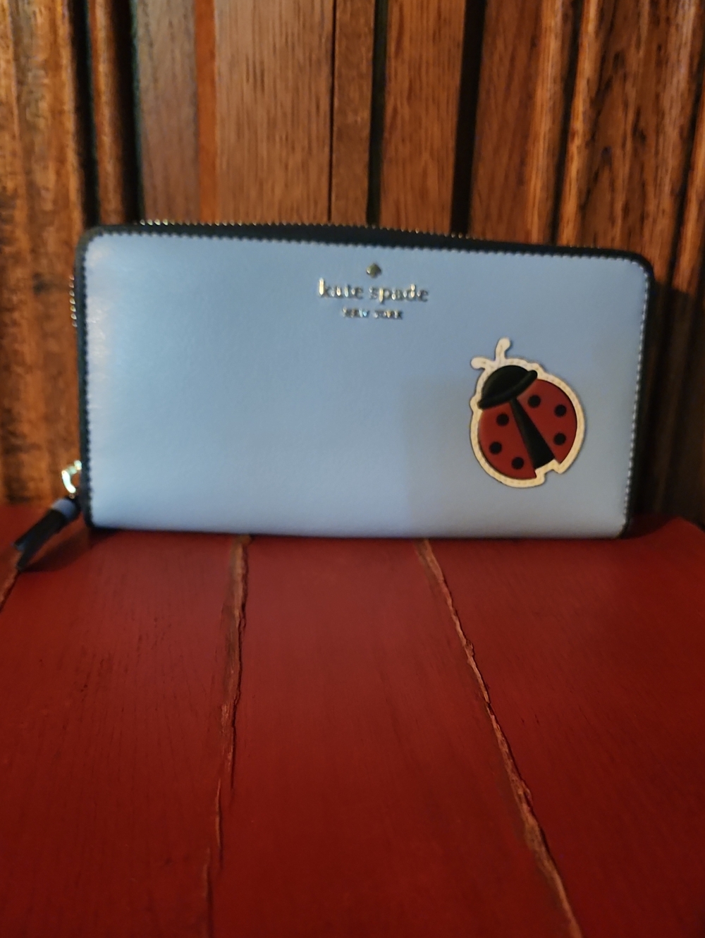 kate spade baby blue zip-around wallet with ladybug patch